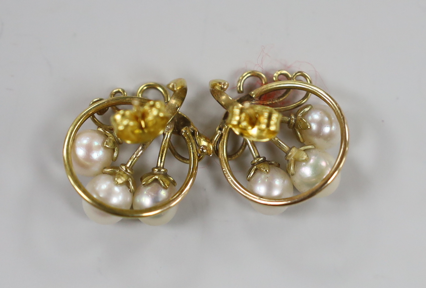 A pair of yellow metal and three stone cultured pearl set earrings, 16mm, gross weight 5.6 grams.